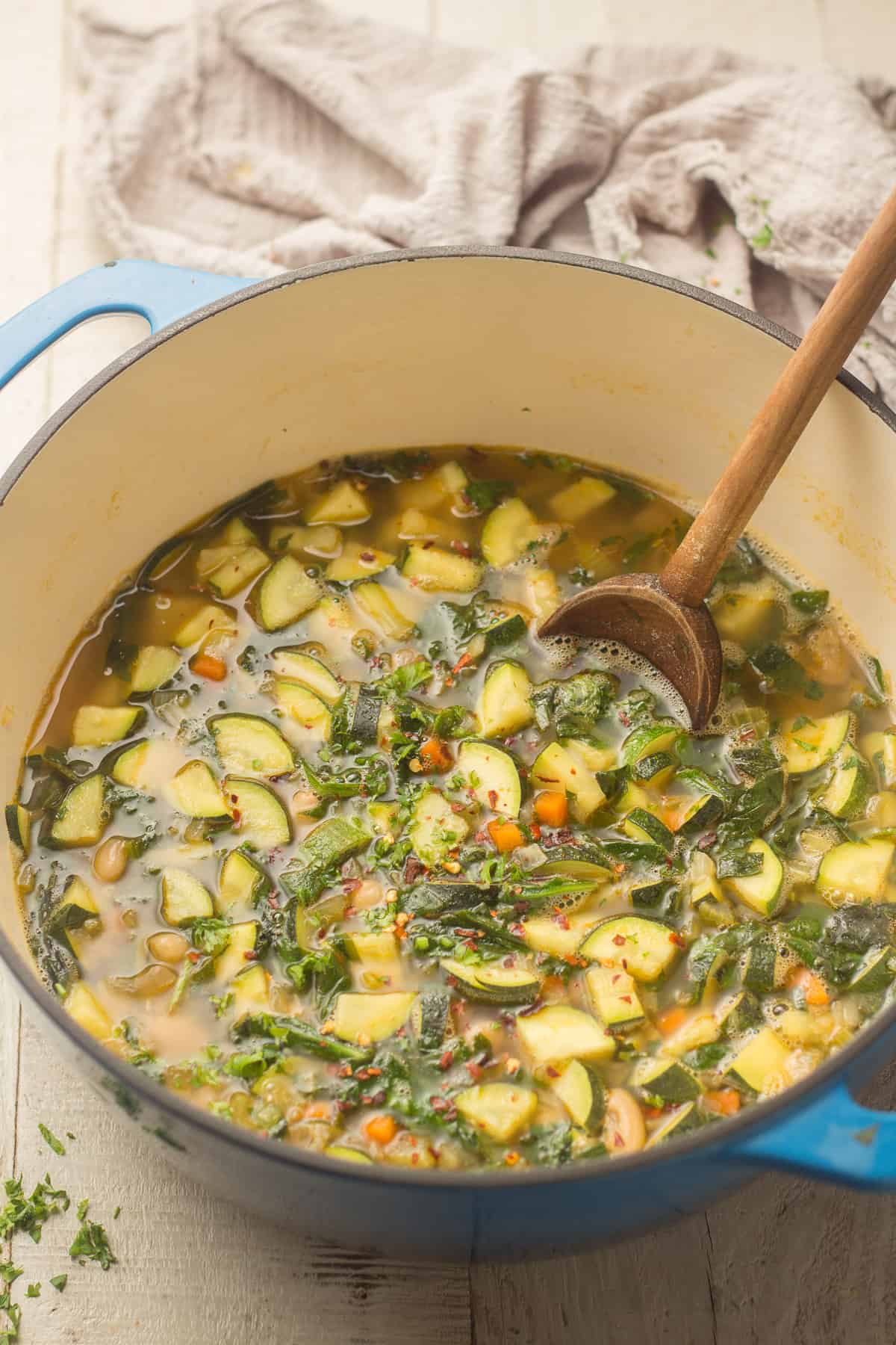 Pot of Zucchini Soup with a Wooden Spoon