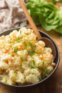 Close up of Vegan Potato Salad in a Bowl with Serving Spoon