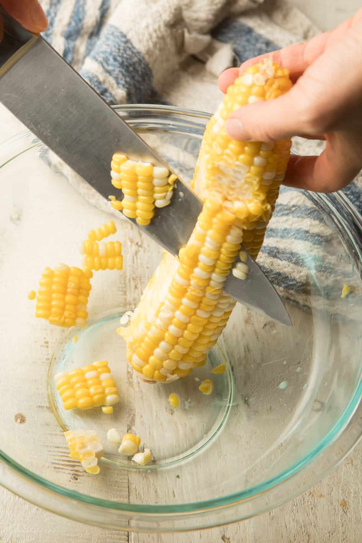 Hand Cutting Corn From a Cob into a Bowl