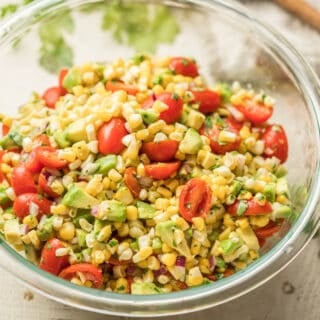 Close Up of Avocado Corn Salad in a Glass Bowl