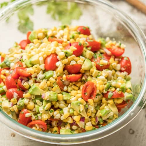 Close Up of Avocado Corn Salad in a Glass Bowl