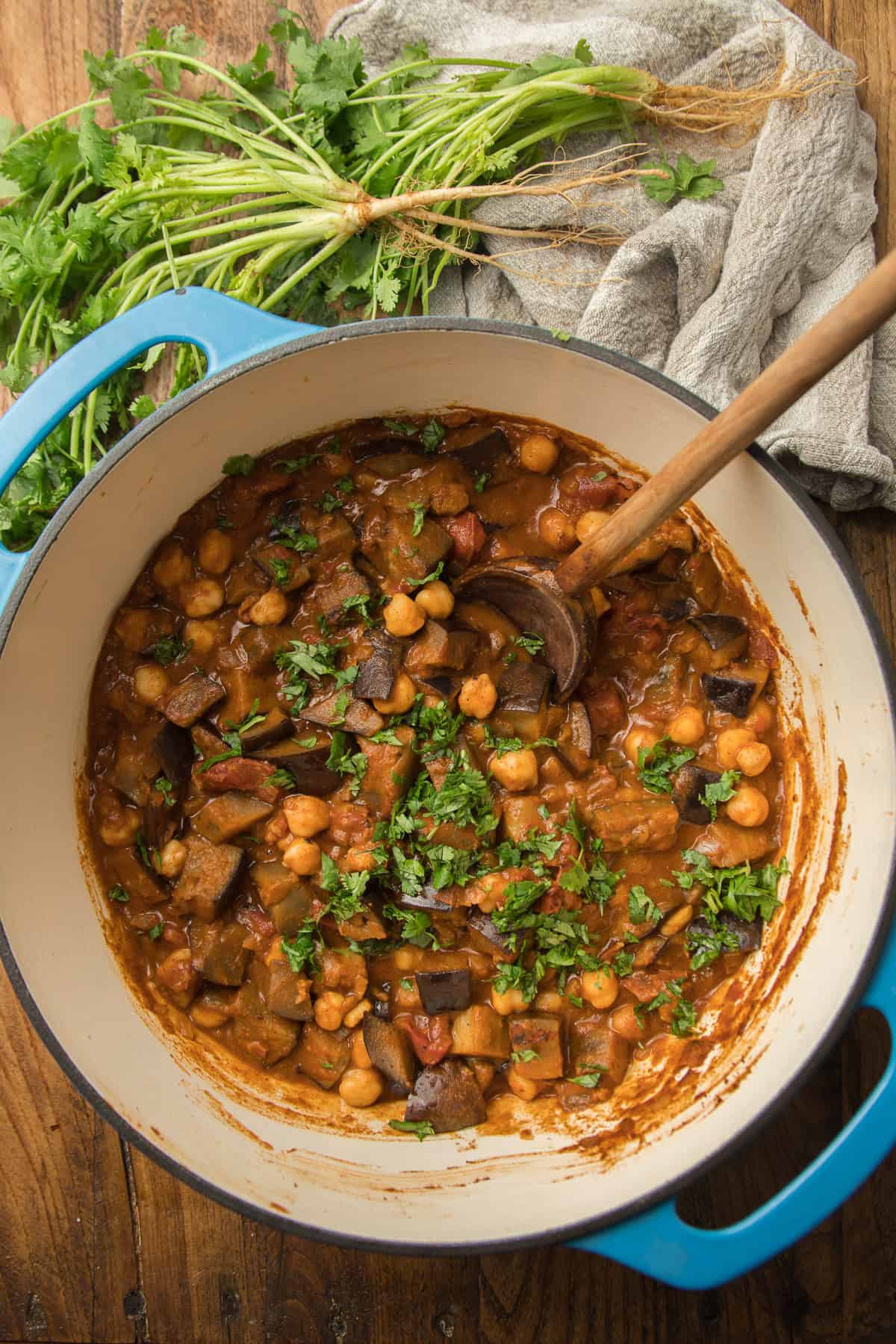 Pot of Eggplant Curry with a Wooden Spoon