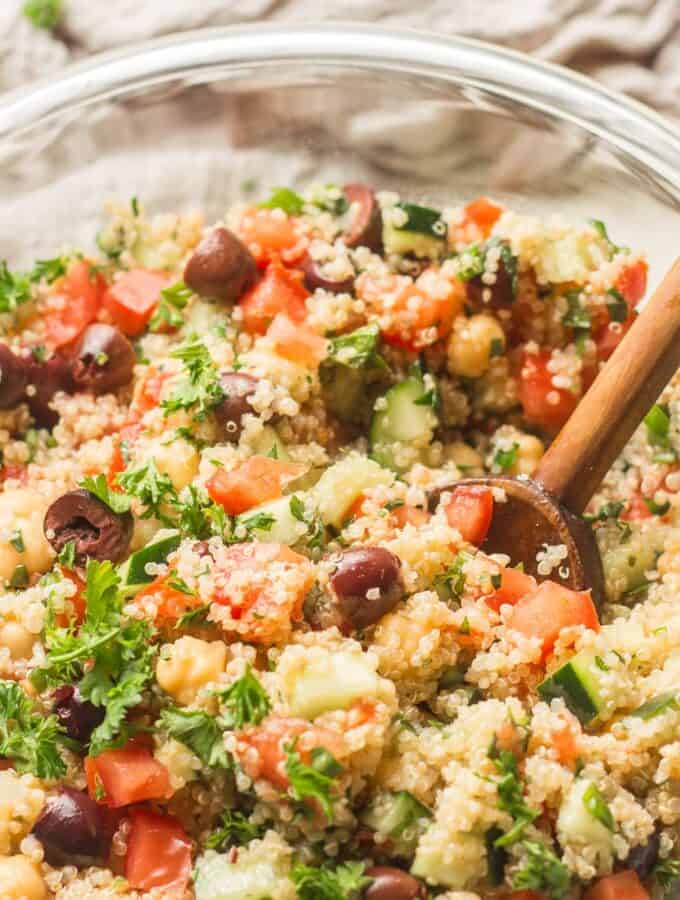Close Up of Mediterranean Quinoa Salad in a Bowl with Wooden Spoon