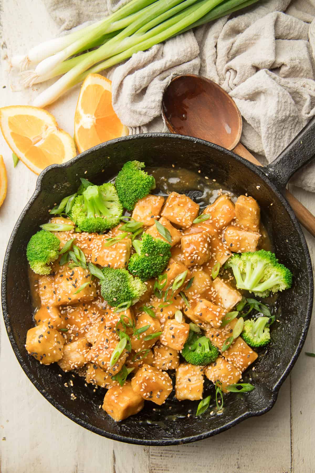 Skillet of Crispy Orange Tofu and Broccoli with Spoon on the Side