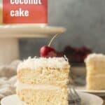 Slice of Vegan Coconut Cake on a Plate with Text Overlay Reading "Vegan Coconut Cake"