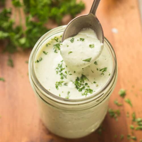 Spoon Scooping Vegan Ranch Dressing From a Jar