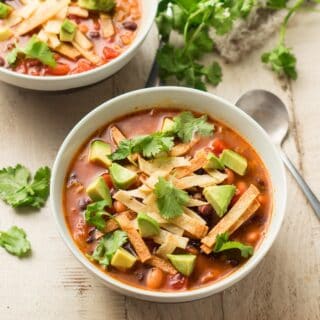 Bowl of Vegan Tortilla Soup with Spoon on the Side