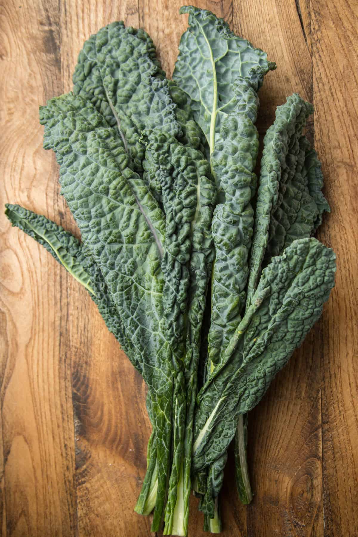 Bunch of Lacinato Kale on a Wood Surface.
