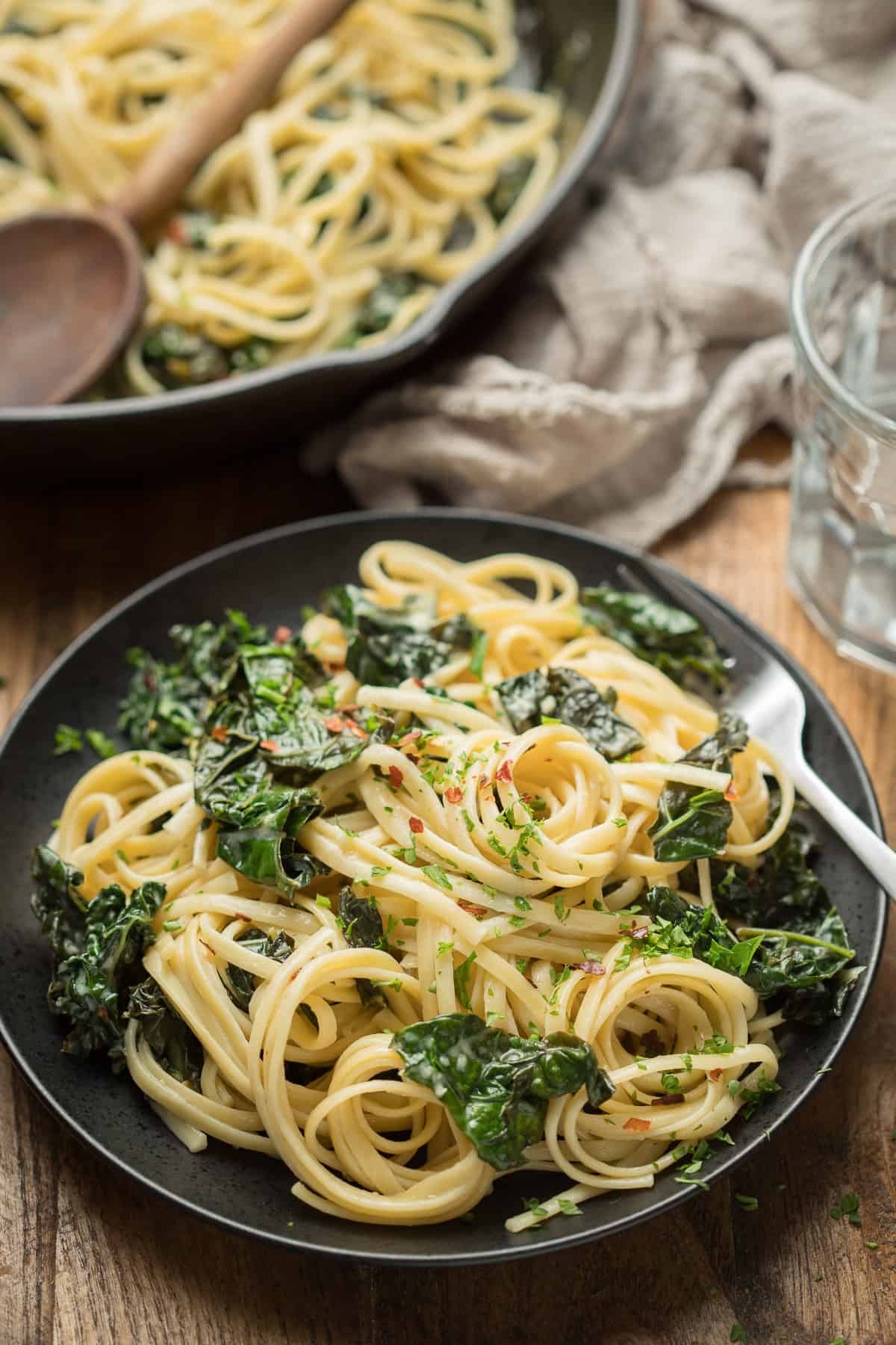 Plate of Creamy Kale Pasta with Skillet in the Background