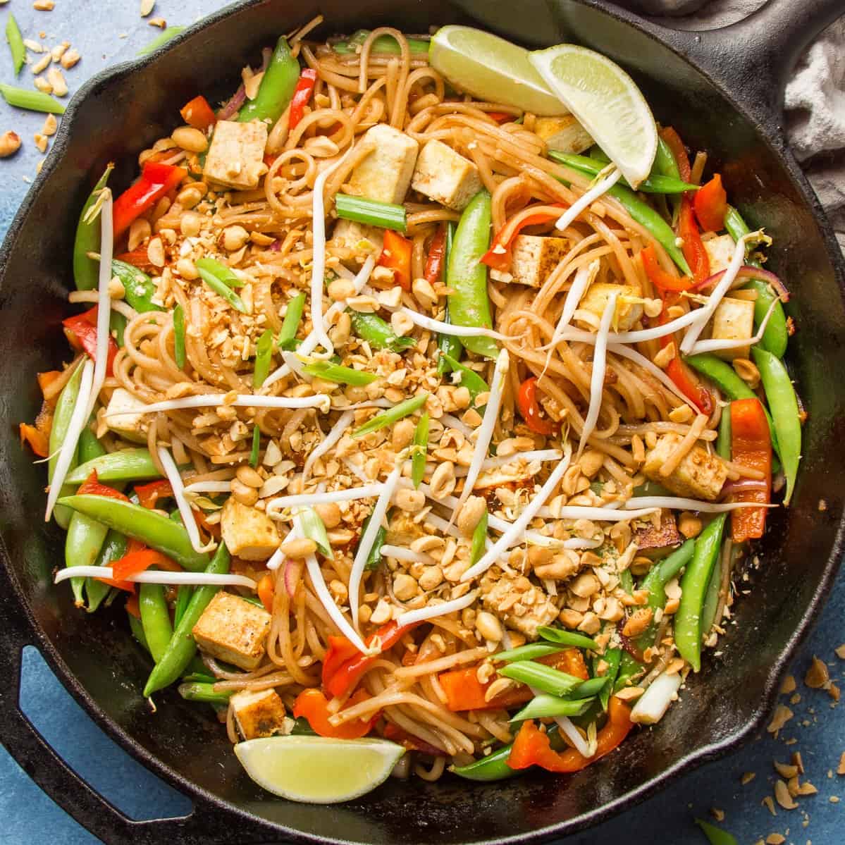 Skillet of Vegan Pad Thai with Lime Slices