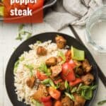Plate of Seitan Stir-Fry and Rice with Text Overlay Reading "Vegan Pepper Steak"