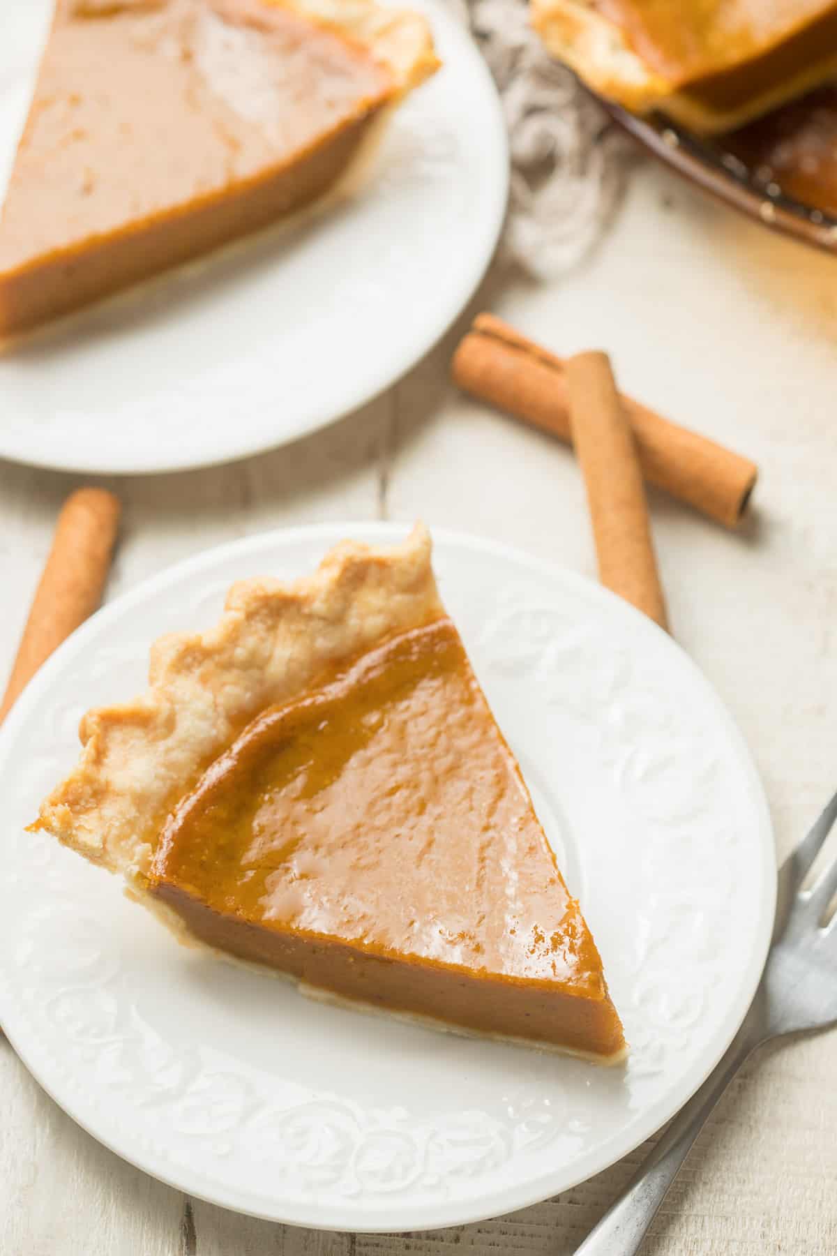 Two plates of Vegan Pumpkin Pie slices without toppings.