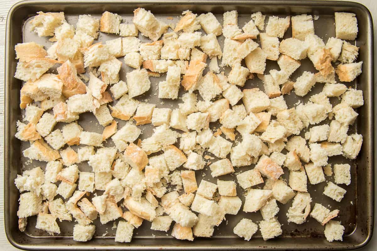 Bread cubes on a baking sheet.