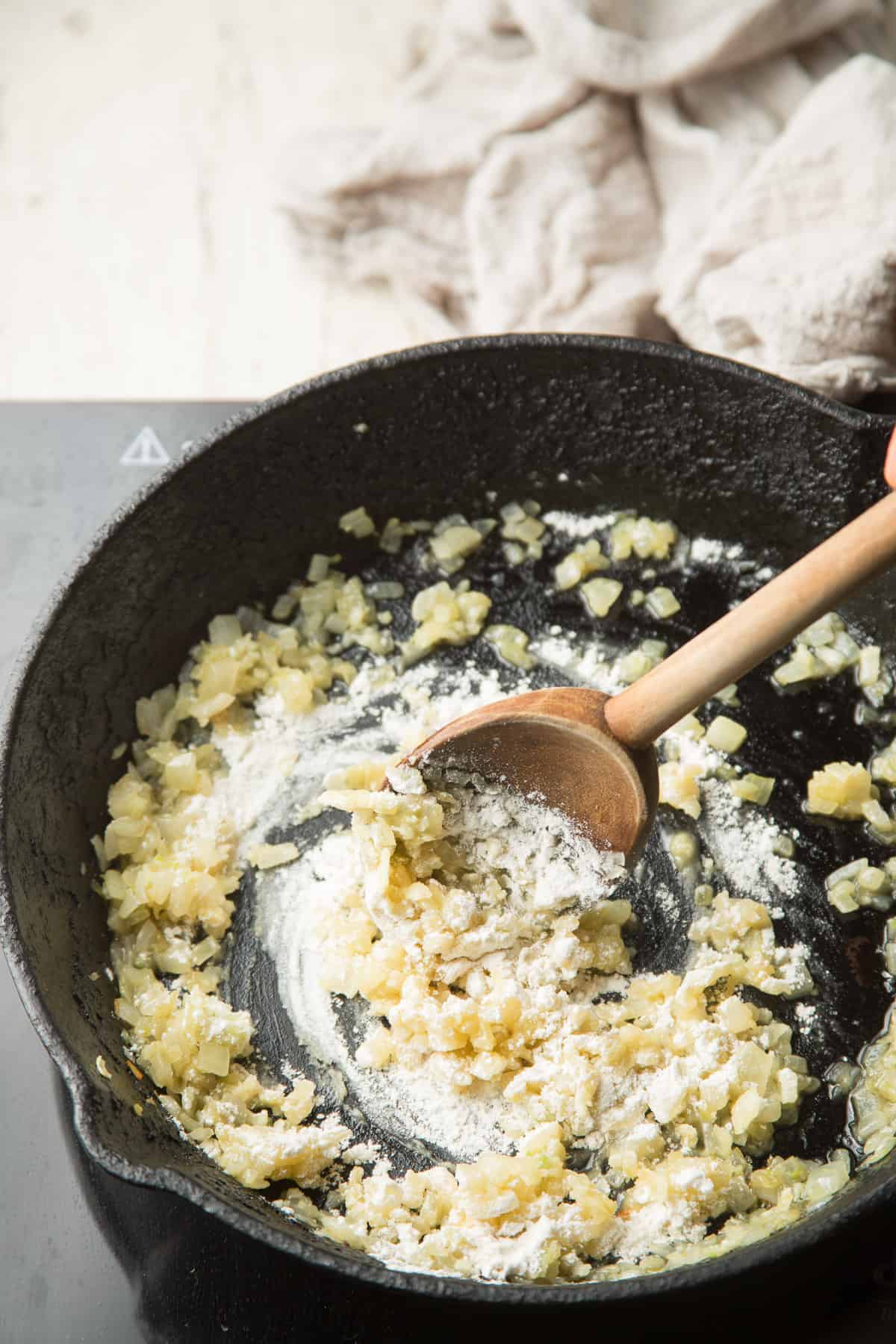 Flour and onions cooking in a skillet.