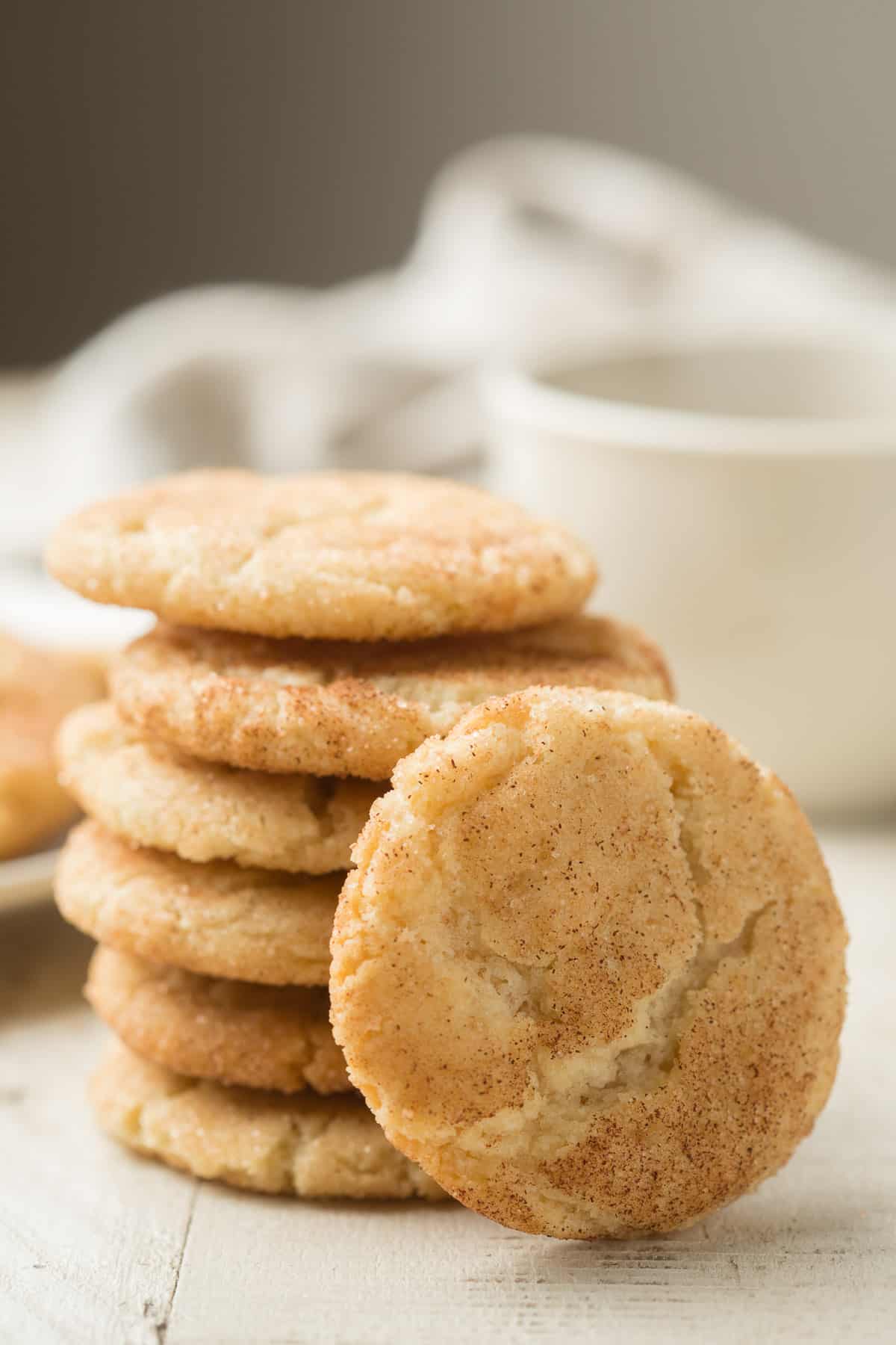 Stack of Vegan Snickerdoodles with Tea Cup on the side.