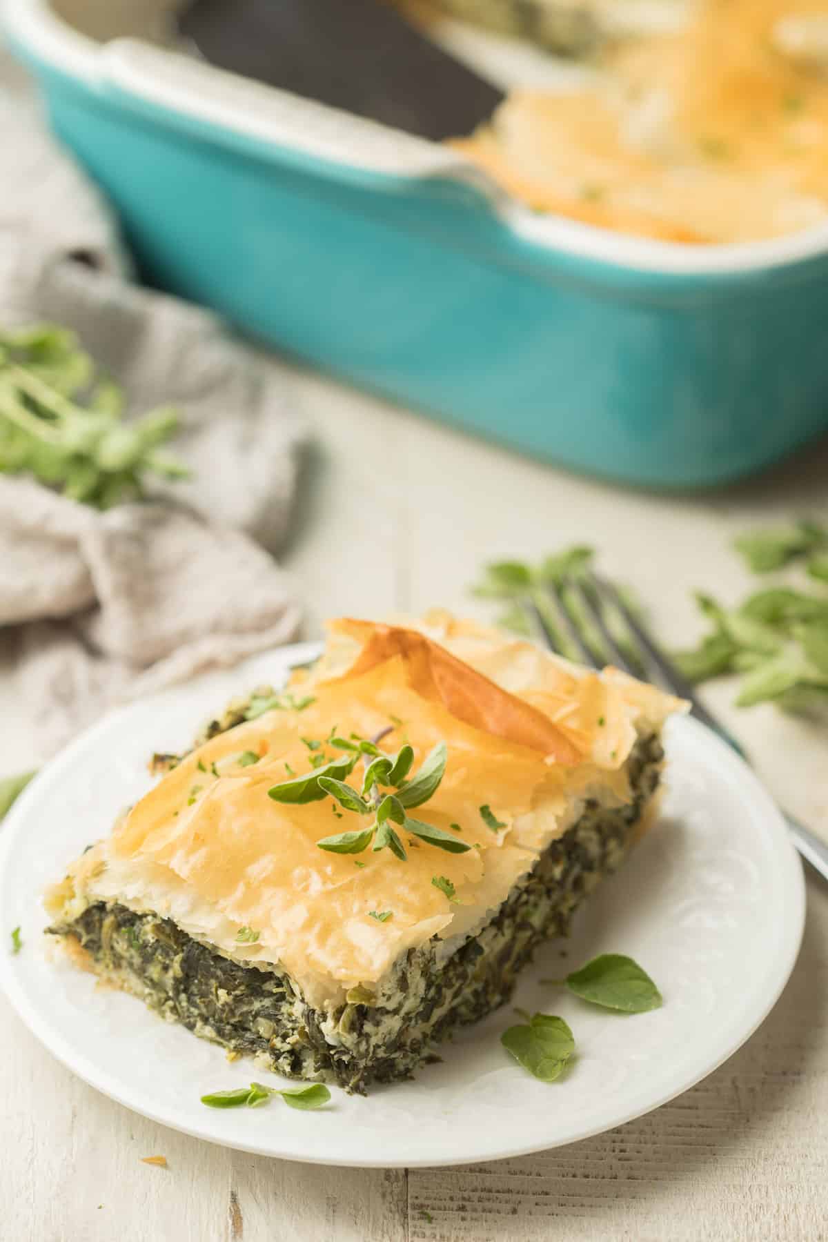 Slice of Vegan Spanakopita on a plate with fork on the side.