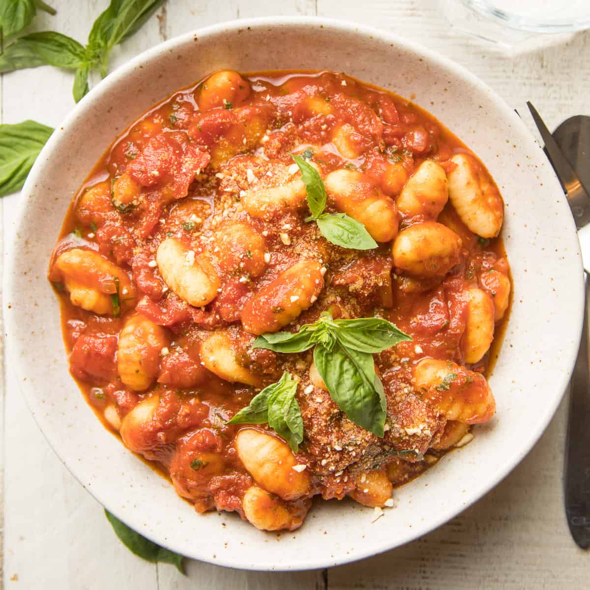 Bowl of Gnocchi with Tomato Sauce with fresh basil on top.