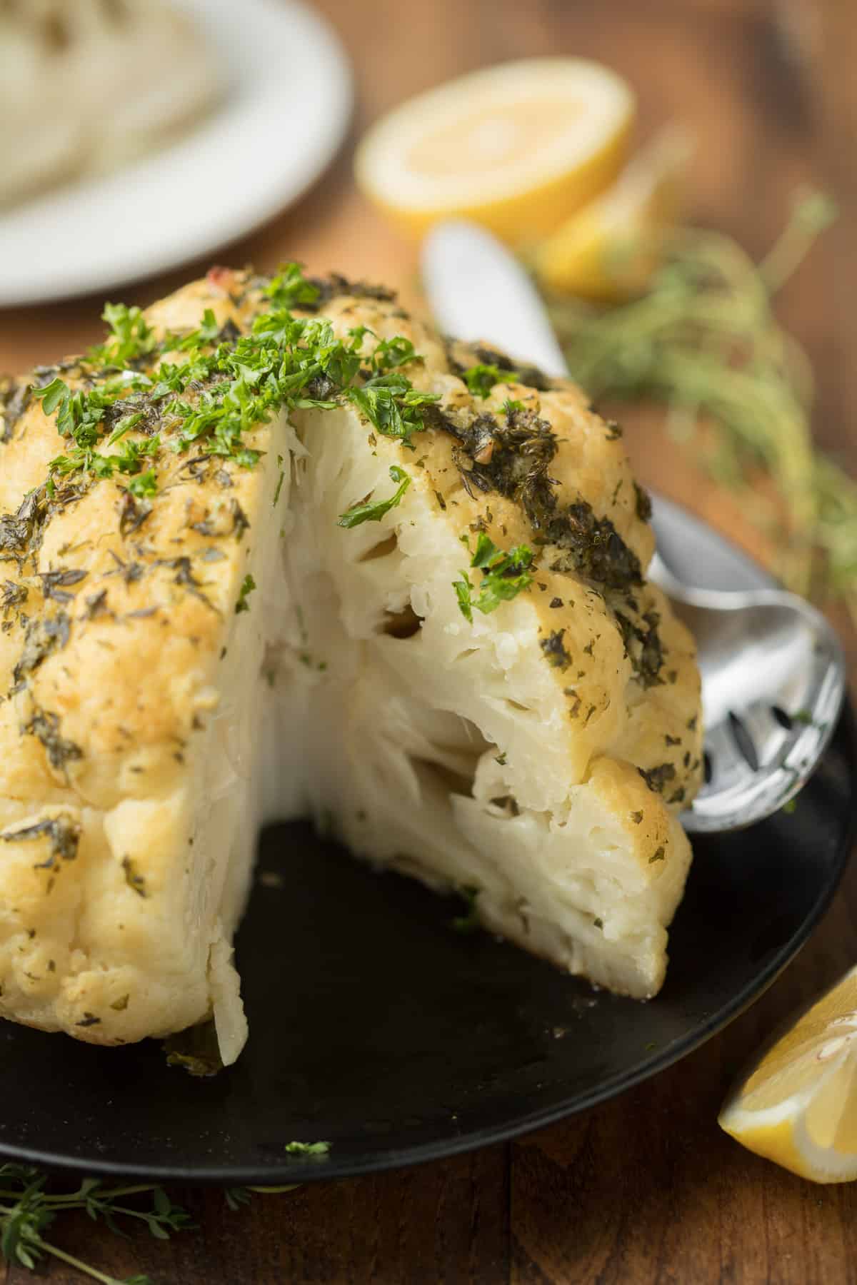 Whole Roasted Cauliflower with a Wedge Cut out.