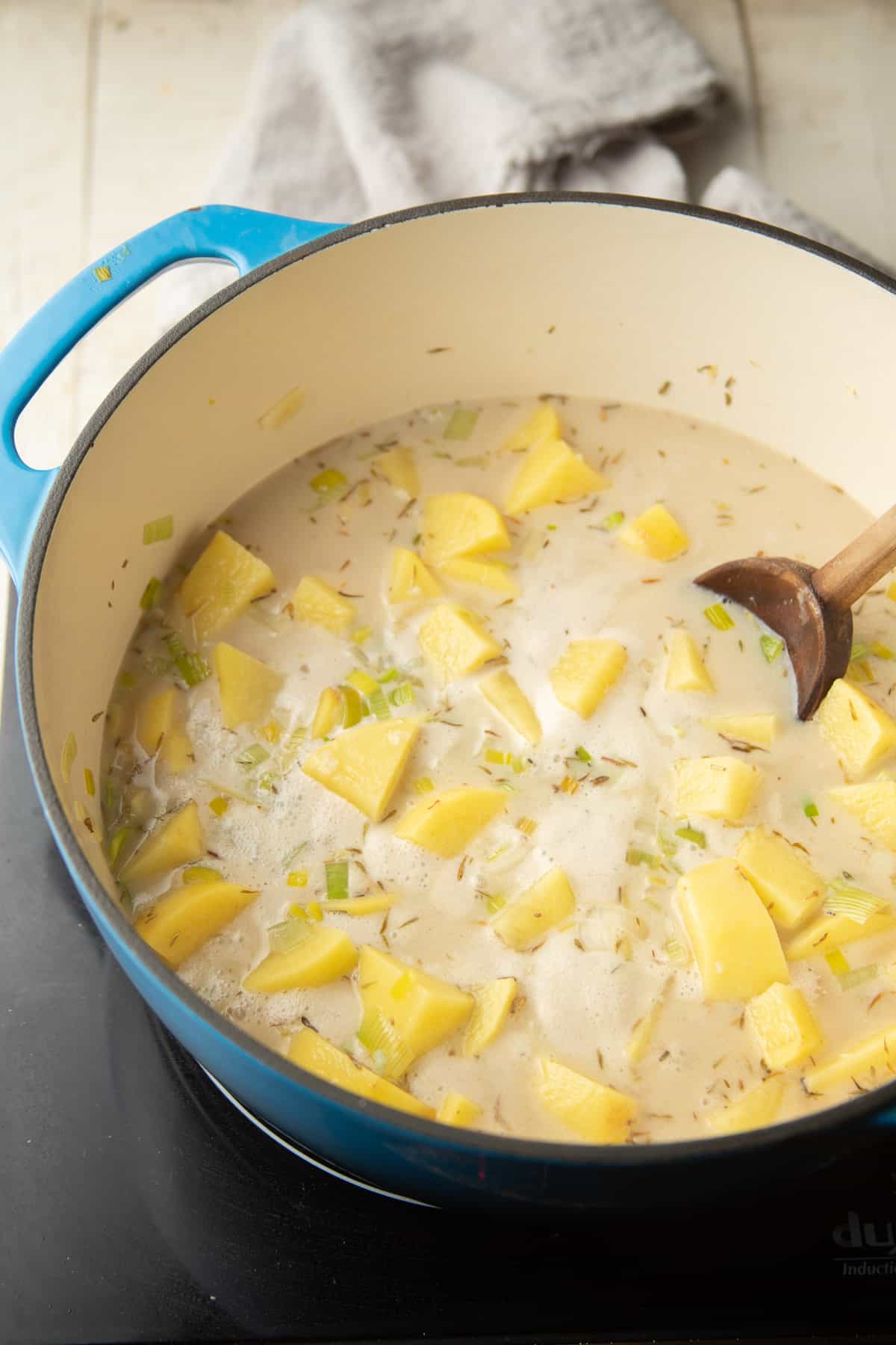 Vegan Potato Leek Soup simmering in a pot.