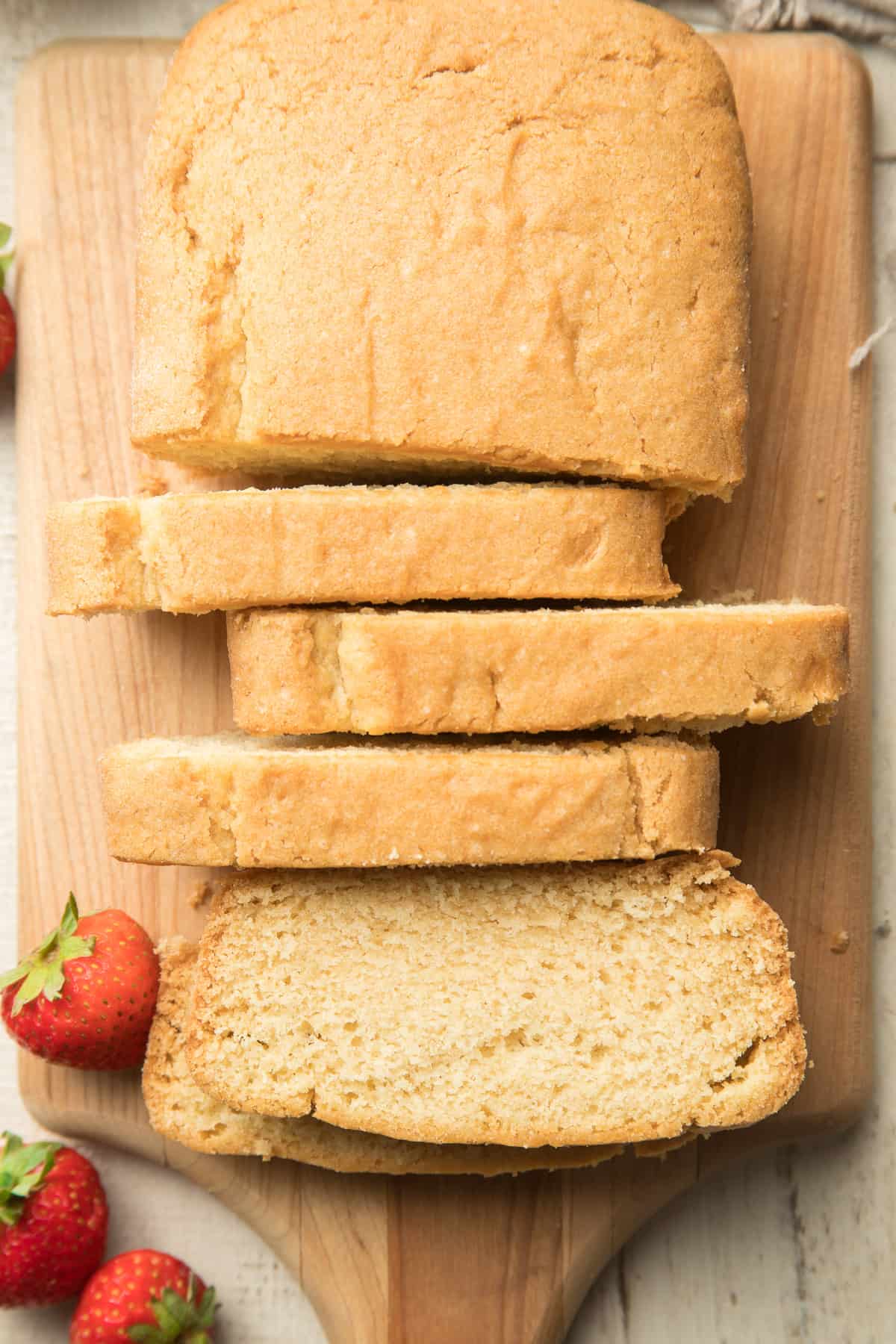 Partially sliced Vegan Pound Cake on a cutting board.