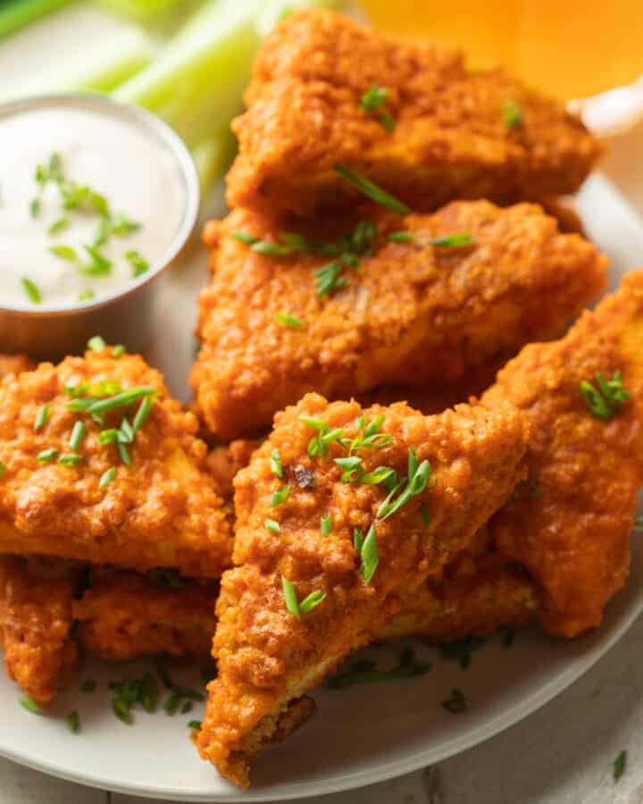 Close up of Buffalo Tofu Wings on a plate with dressing.