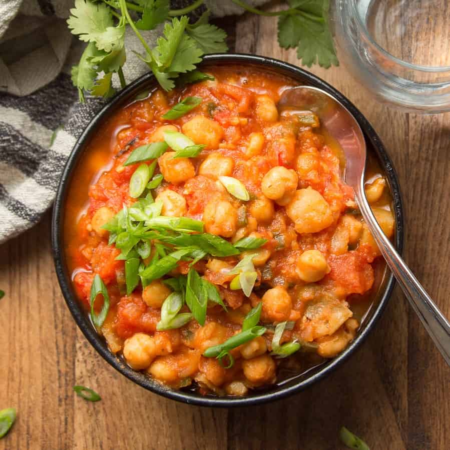 Bowl of Chickpea Stew with cilantro and scallions on top.