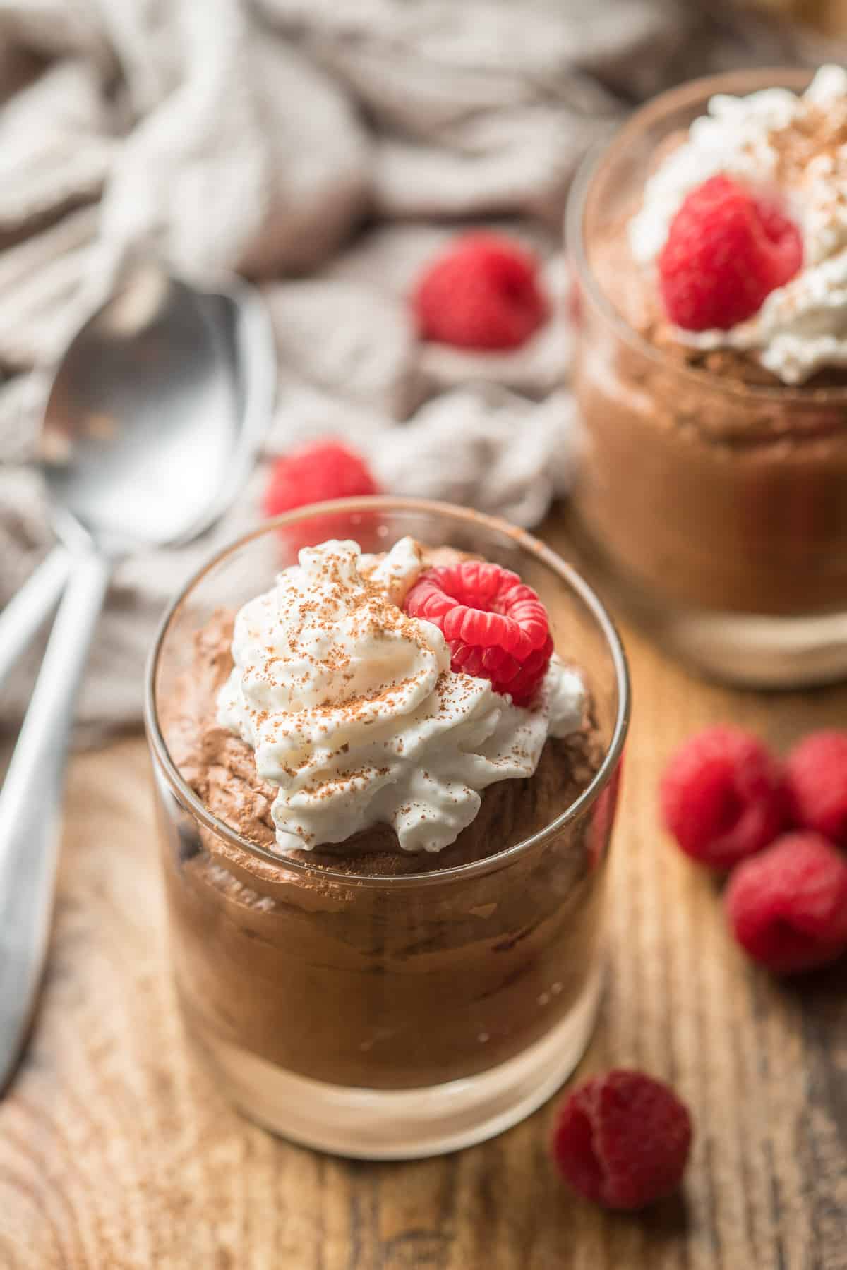 Two cups of Vegan Chocolate Mousse with spoons on the side.