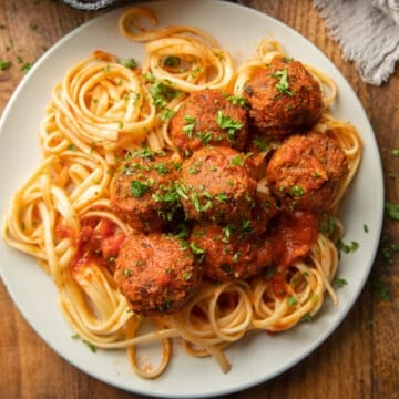 Plate of spaghetti topped with Vegan Meatballs.