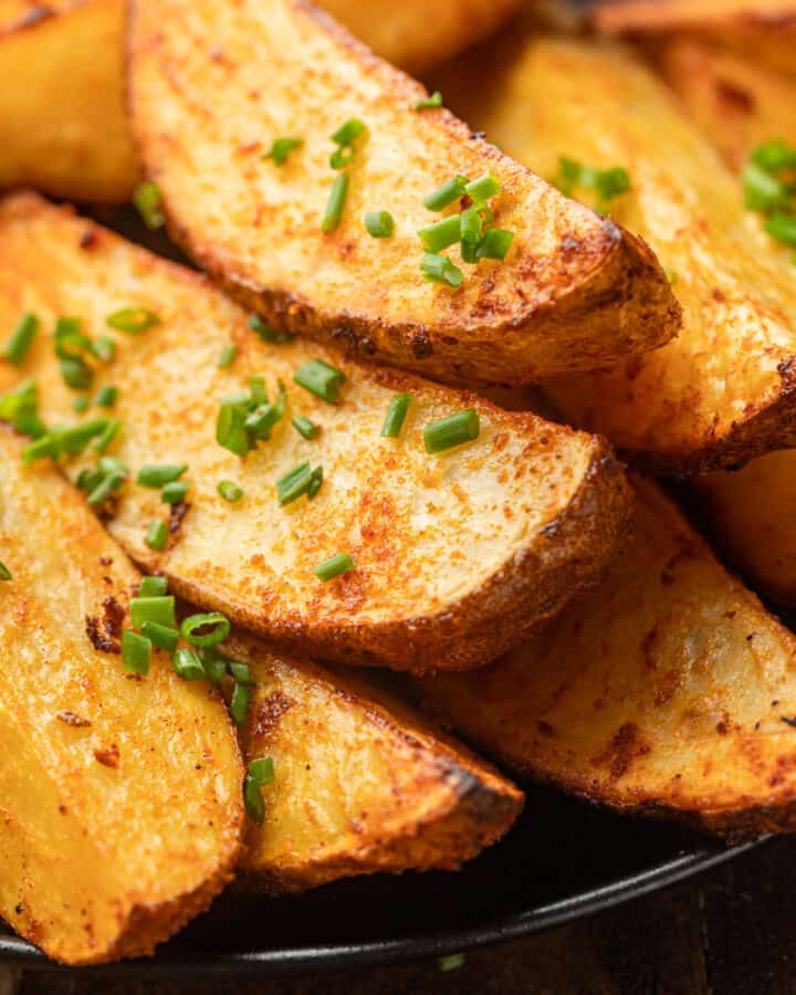 Close Up of Air Fryer Potato Wedges topped with fresh chives.