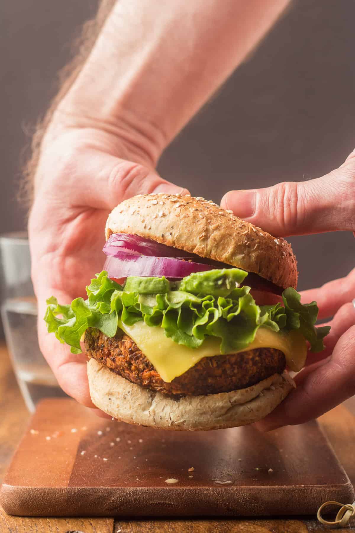 Pair of hands holding a quinoa burger.