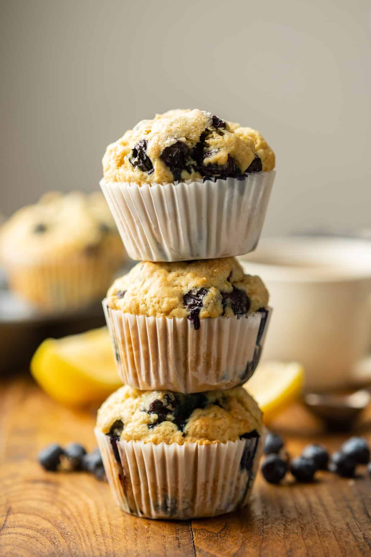 Three Vegan Blueberry Muffins arranged in a stack.