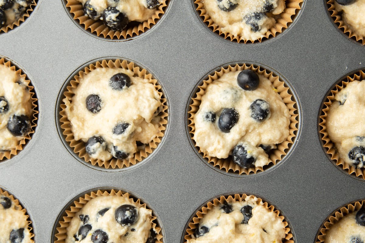 Vegan Blueberry Muffin batter in a muffin tin.