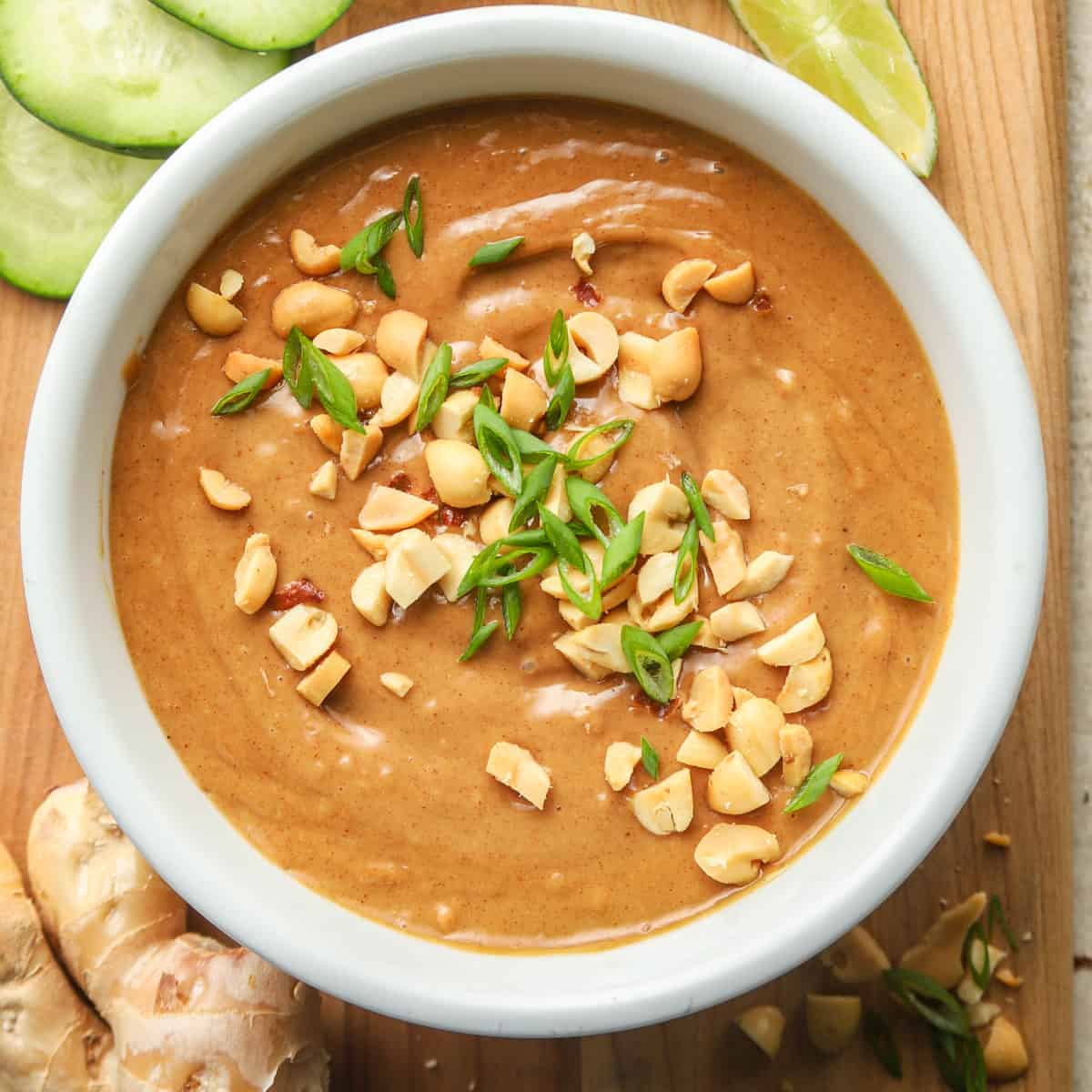 Bowl of Vegan Peanut Sauce topped with peanuts and scallions.