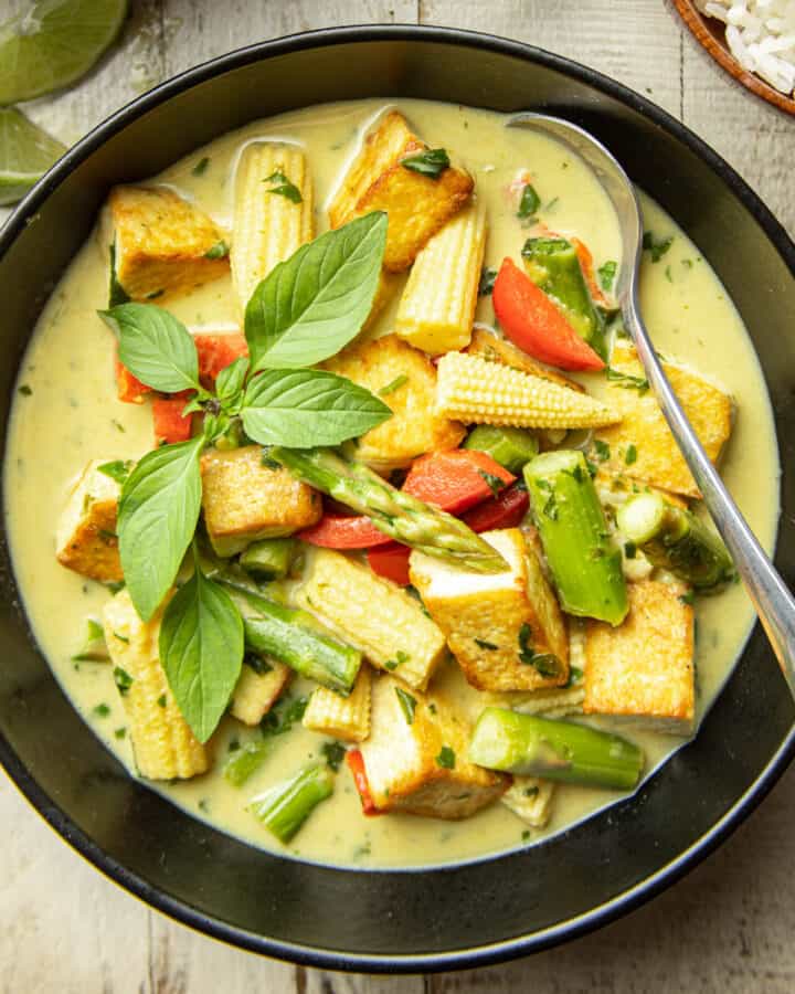 Bowl of Vegan Green Curry with a spoon.