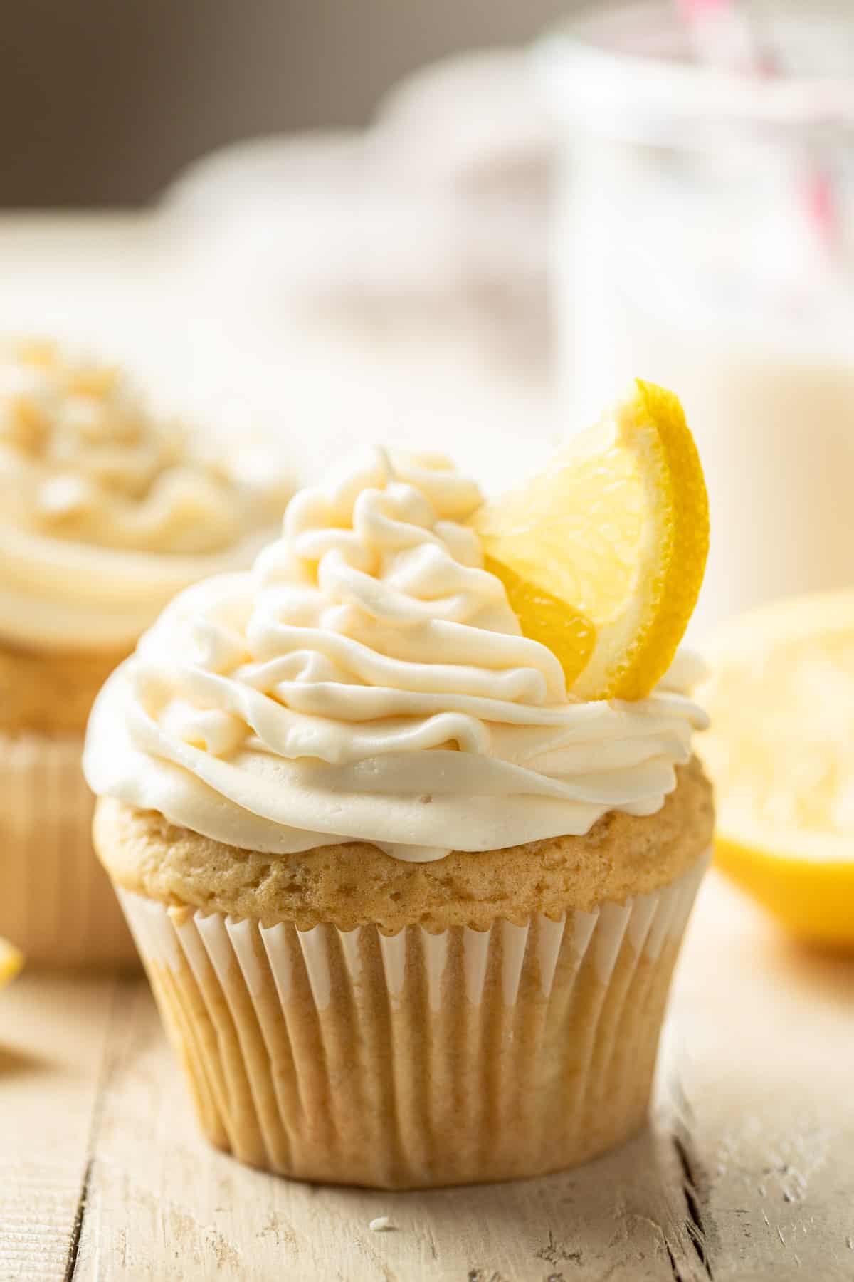 Vegan Lemon Cupcakes with frosting and lemon slice on top.