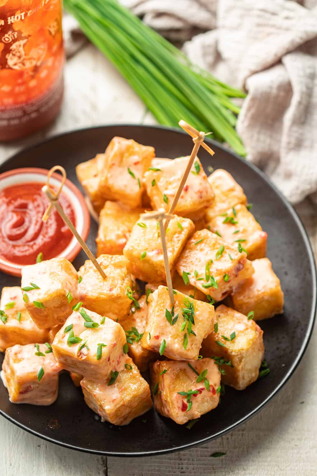 Plate of Bang Bang Tofu with skewers in some of the pieces.