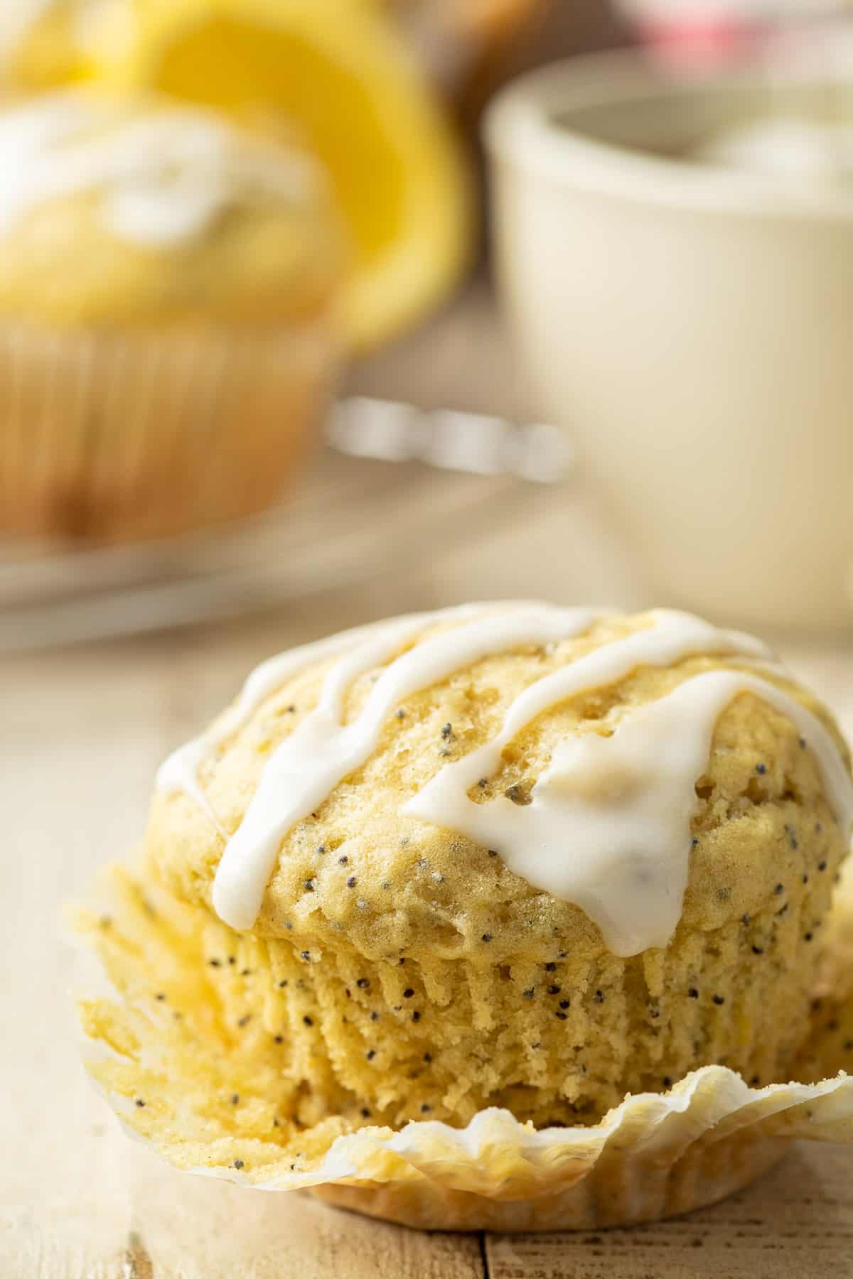 Vegan Lemon Poppy Seed Muffin with the muffin paper partially removed.