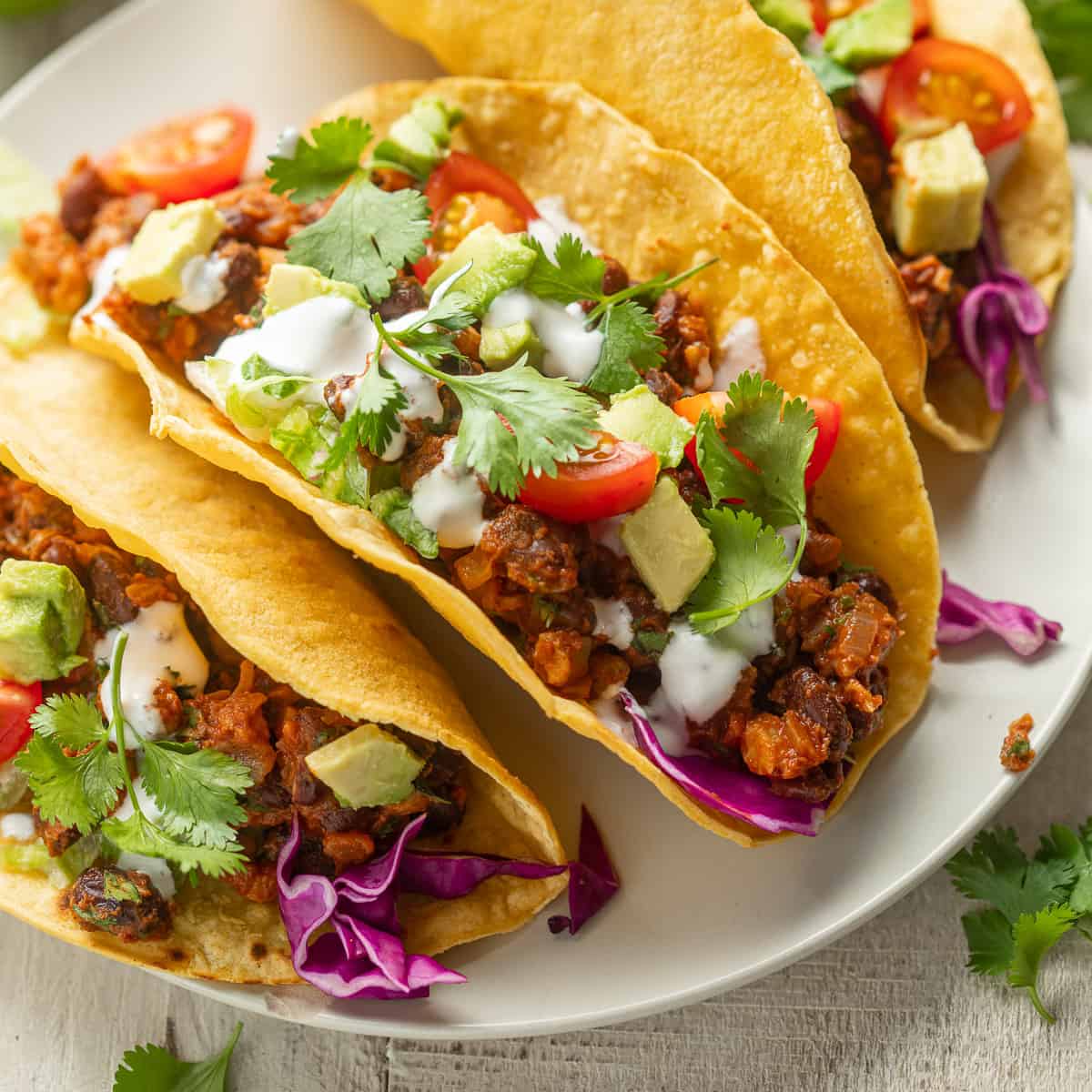 Close up of Three Vegan tacos on a plate.