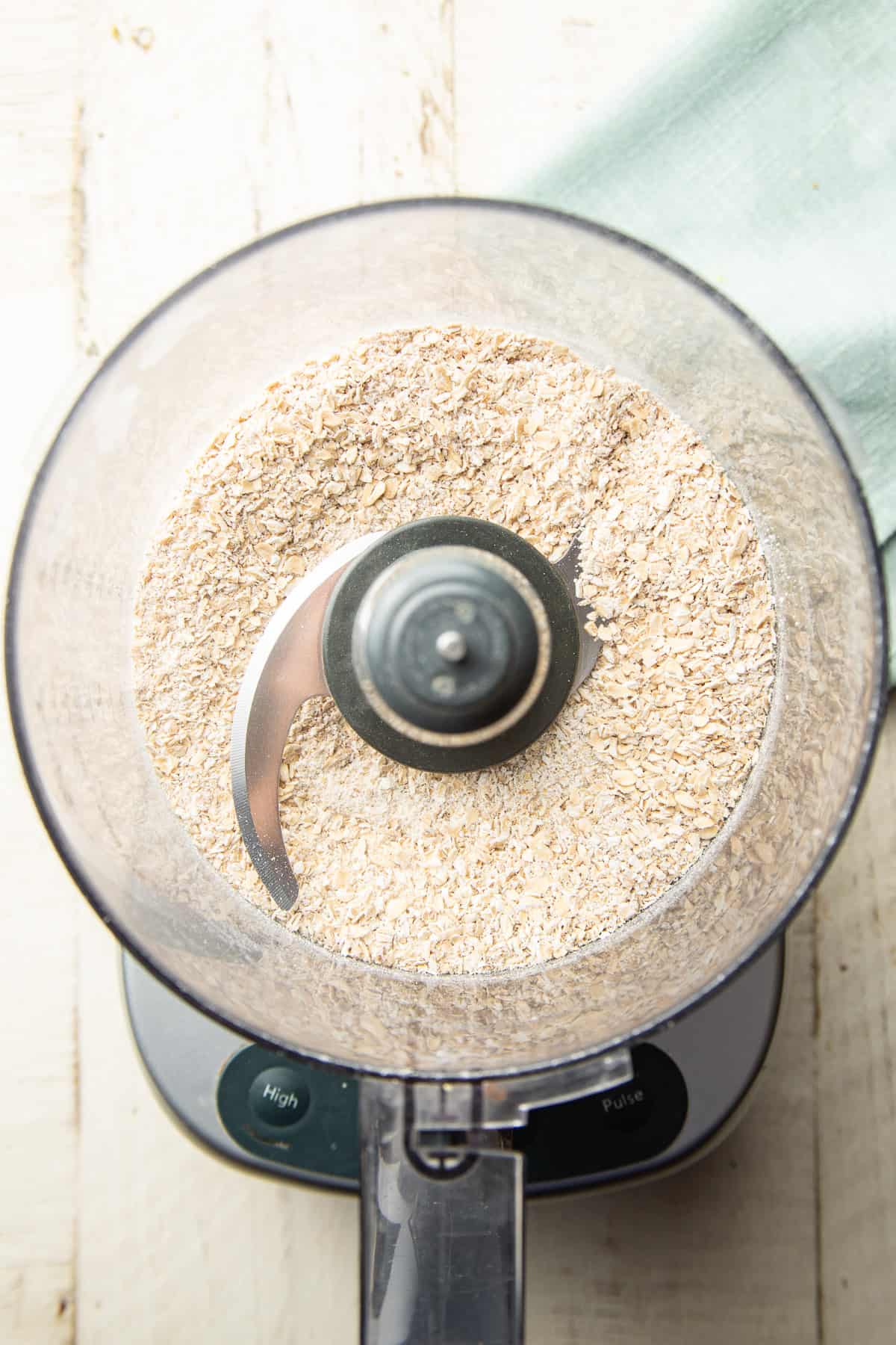 Ground oats in a food processor bowl.