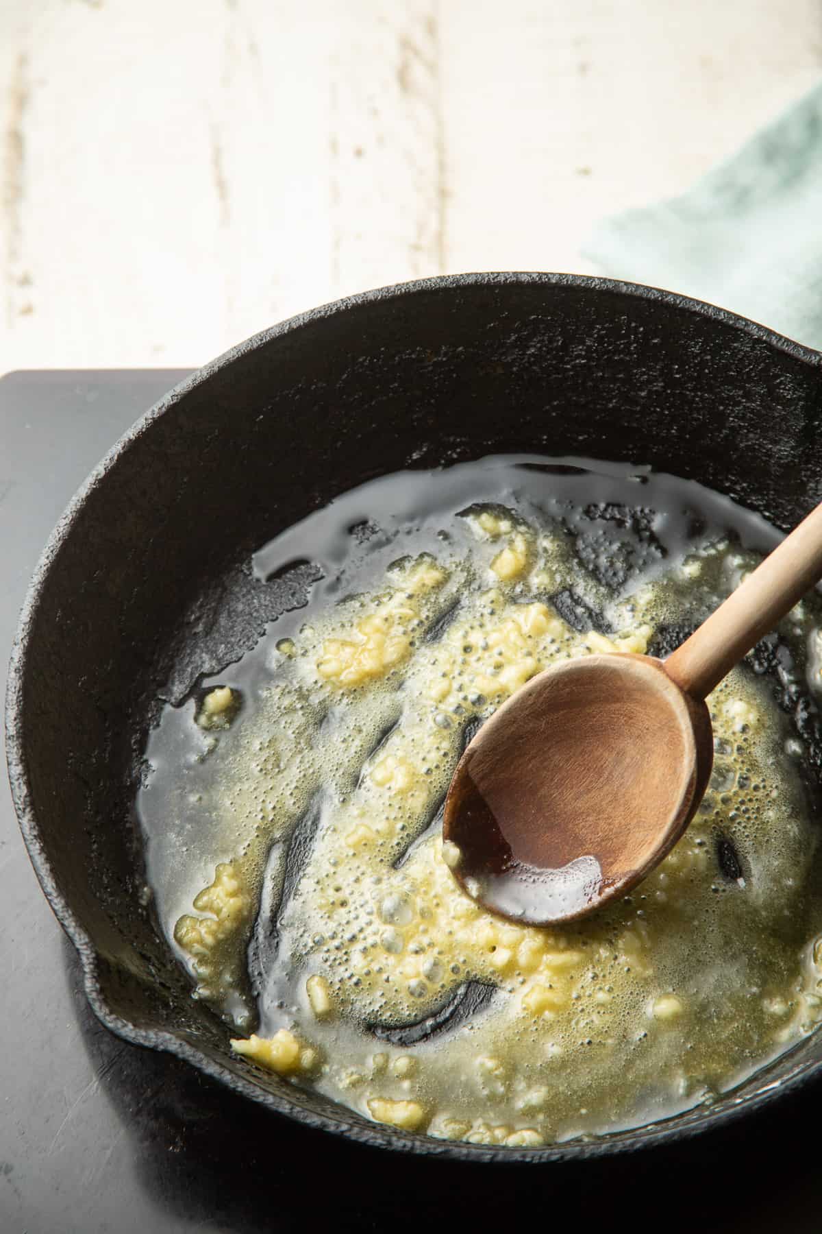 Mixture of garlic, flour and olive oil cooking in a skillet.