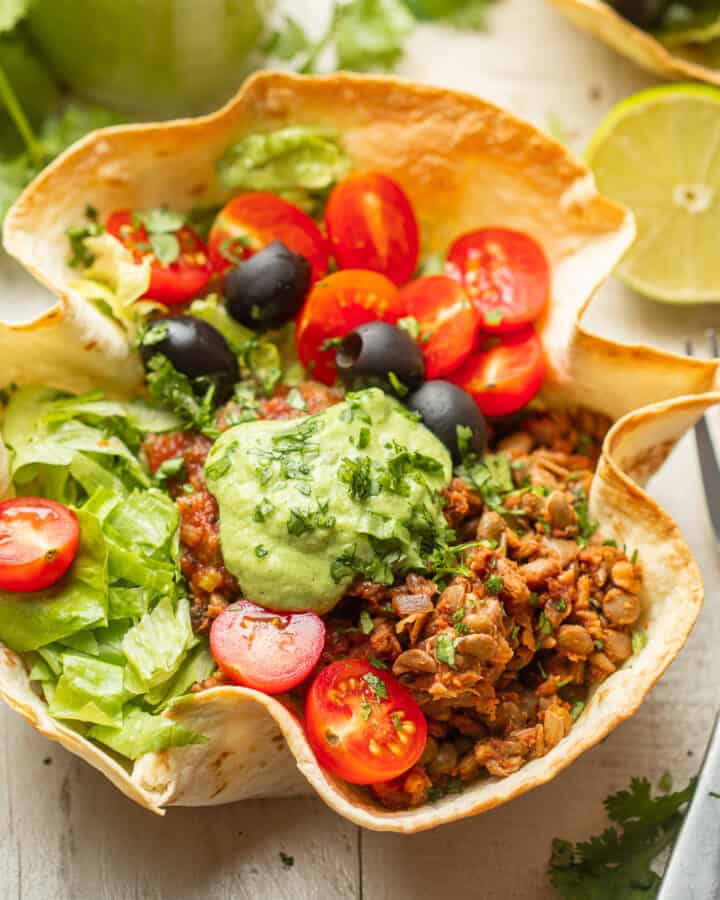 Vegan Taco Salad in a tortilla bowl with forks on the side.