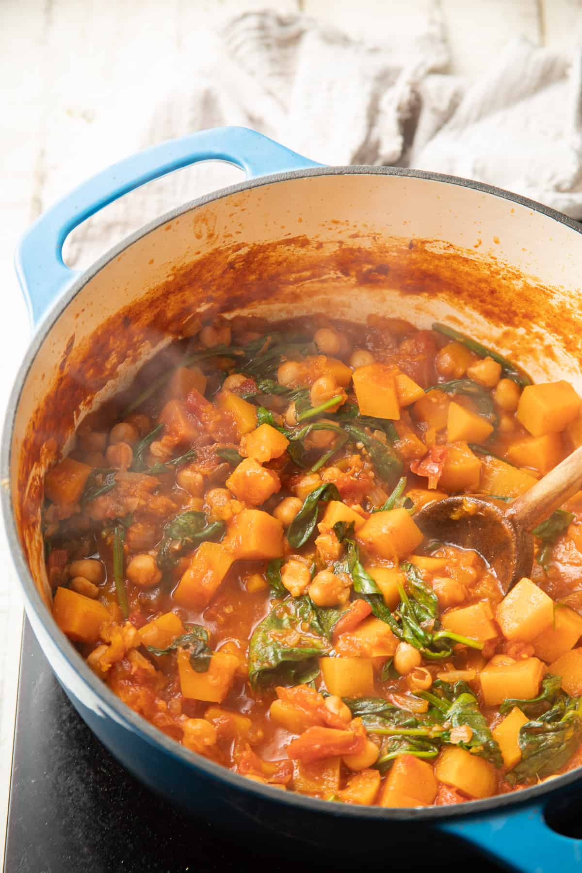 Butternut Squash Stew with spinach simmering in a pot.