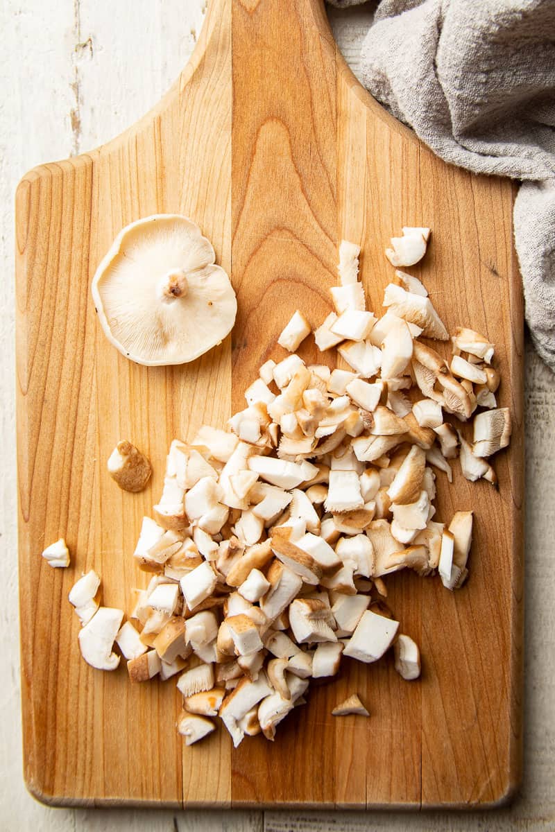 Diced shiitake mushrooms on a cutting board.