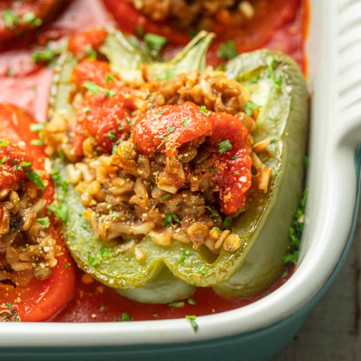 Close up of Vegan Stuffed Peppers in a baking dish.