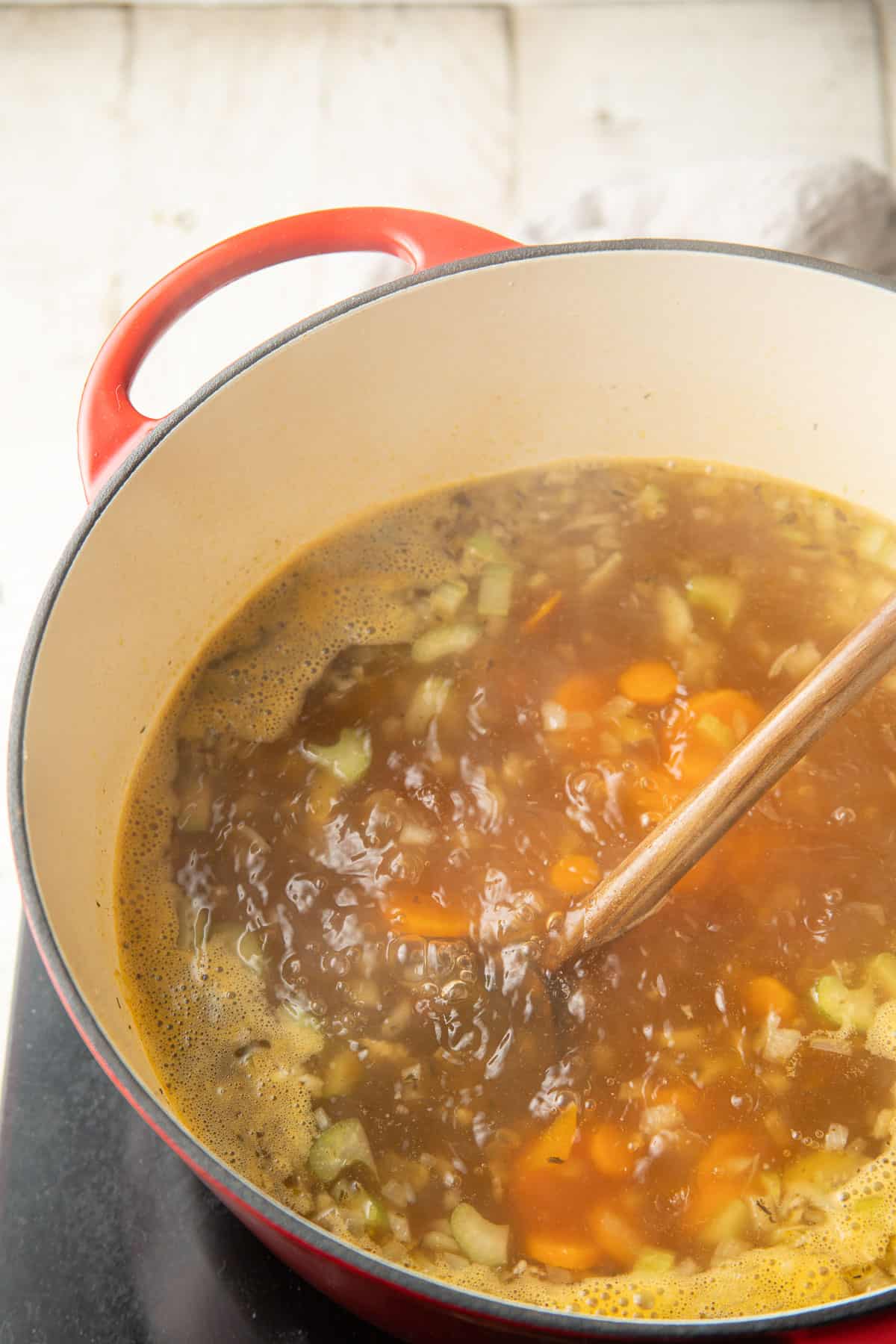 Carrots, onions and celery simmering in vegetable broth.