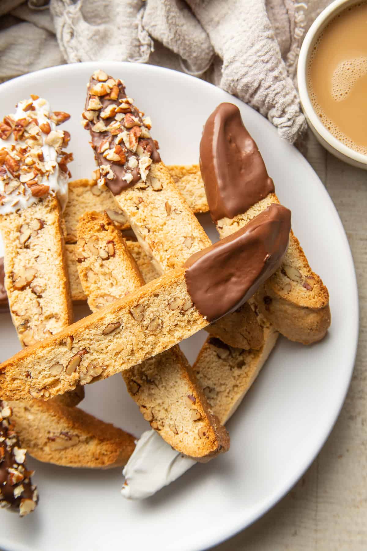 Plate of Vegan Biscotti with coffee cup on the side.
