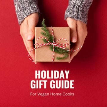Pair of hands holding a wrapped holiday package on a red background with text reading "Holiday Gift Guide For Vegan Home Cooks".