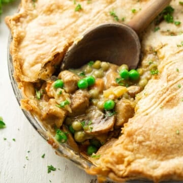 Close up of a spoon scooping filling from a Vegan Pot Pie.