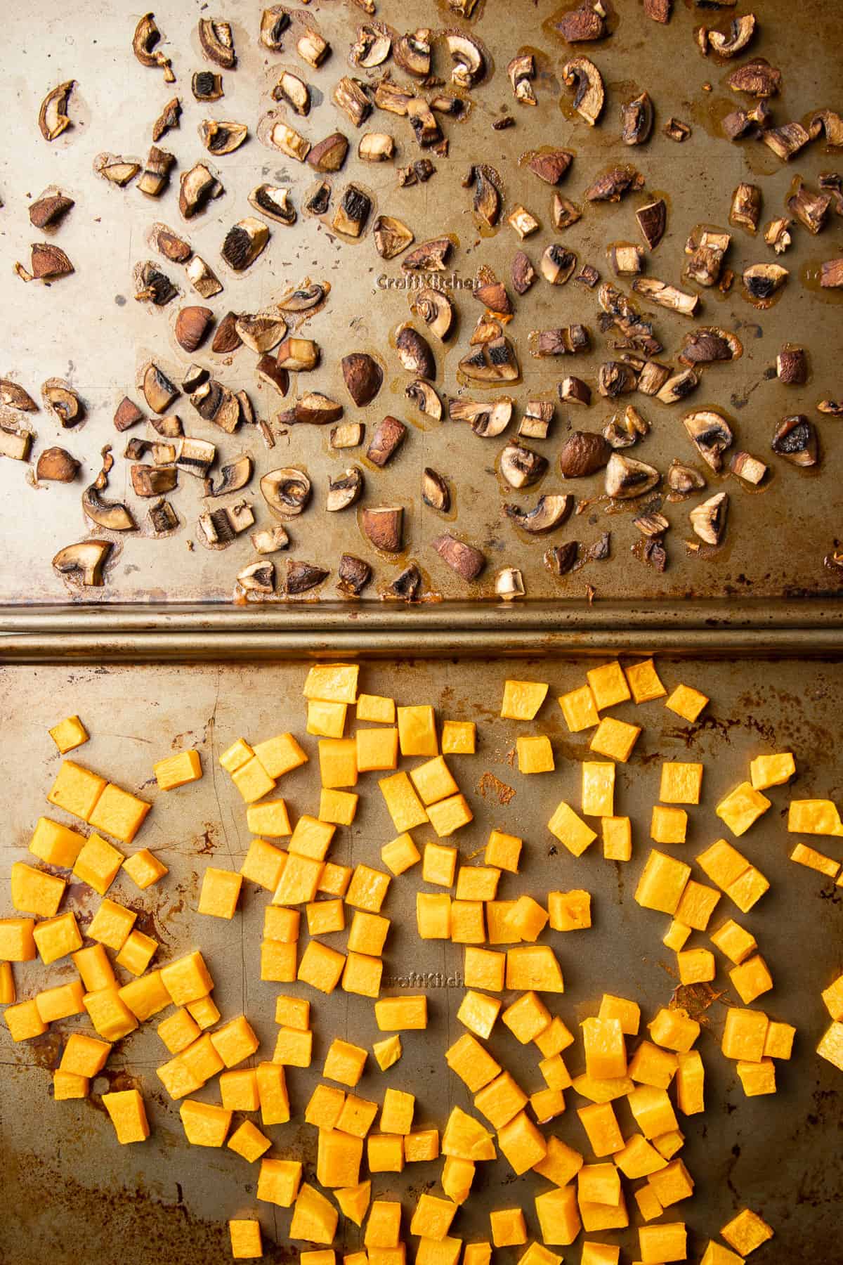 Roasted butternut squash and mushrooms on separate baking sheets.