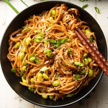 Bowl of Chili Garlic Noodles with chopsticks.